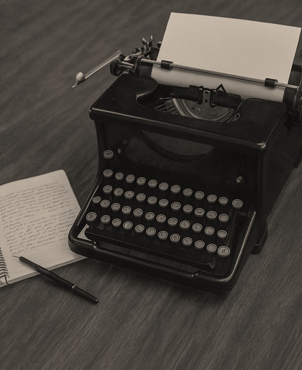 Vintage typewriter on a desk with paper and notebooks
